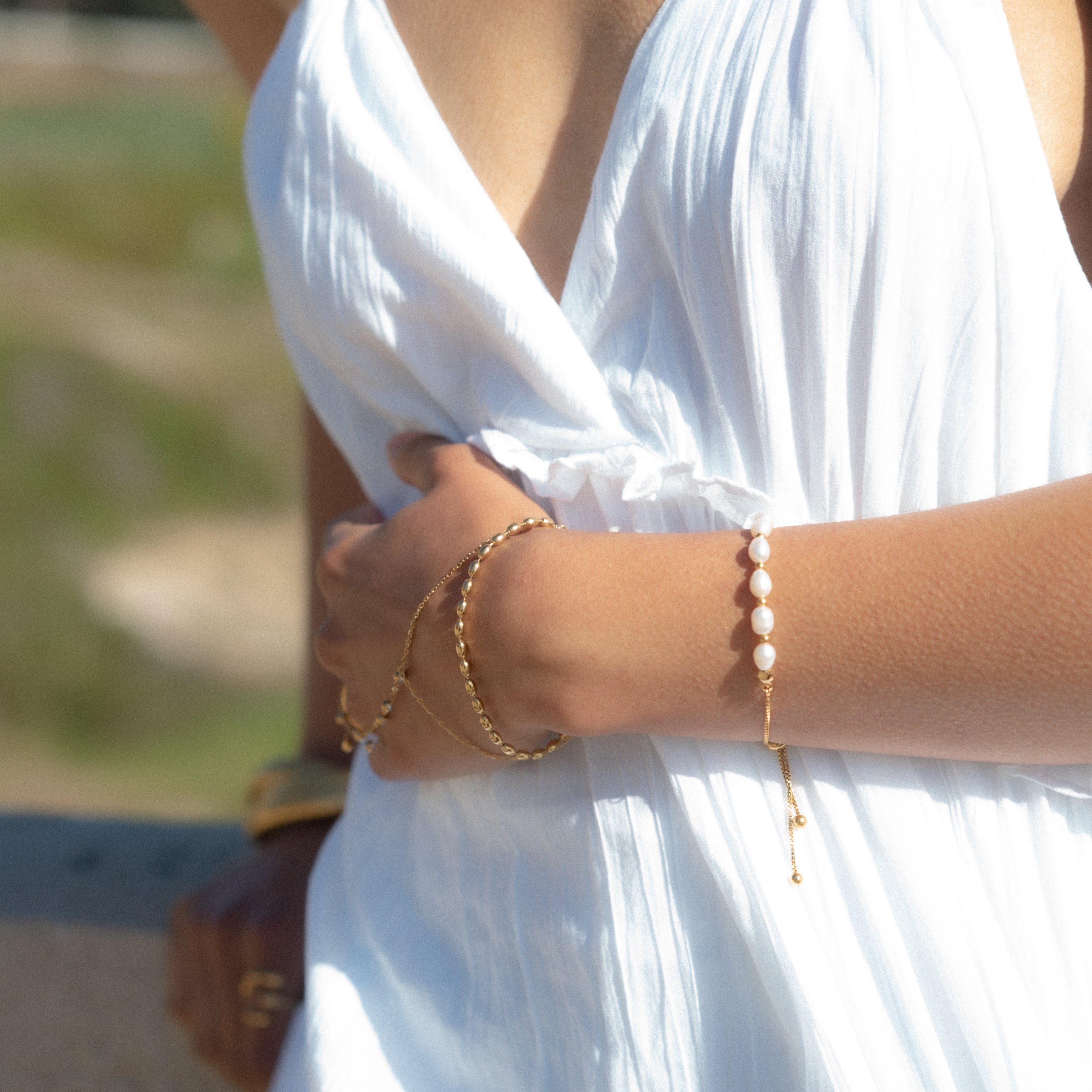 These adjustable bracelets combine the allure of lustrous real fresh water pearls with the timeless charm of gold, creating a statement piece that effortlessly complements any outfit.  18K gold plated on stainless steel. All the bracelets come in a beautiful jewelry pouch.