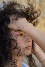 With its subtle charm and minimalist aesthetic, our bracelet is a versatile accessory that effortlessly complements any outfit. Whether you're dressed in casual attire or attending a formal event, this bracelet adds a touch of sophistication and grace, making it a perfect choice for everyday wear or special occasions.  18K gold plated on stainless steel. All the bracelets come in a beautiful jewelry pouch.