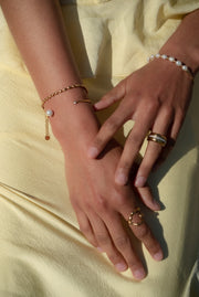 The timeless appeal of our Dainty Bean Design Gold Bracelet makes it a true investment piece. Its classic and versatile design ensures that it will never go out of style, allowing you to enjoy its elegance for years to come. This bracelet is a beautiful addition to any jewelry collection and can be worn alone or layered with other bracelets for a personalized look.  18K gold plated on stainless steel. All the bracelets come in a beautiful jewelry pouch.