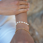 These adjustable bracelets combine the allure of lustrous real fresh water pearls with the timeless charm of gold, creating a statement piece that effortlessly complements any outfit.  18K gold plated on stainless steel. All the bracelets come in a beautiful jewelry pouch.
