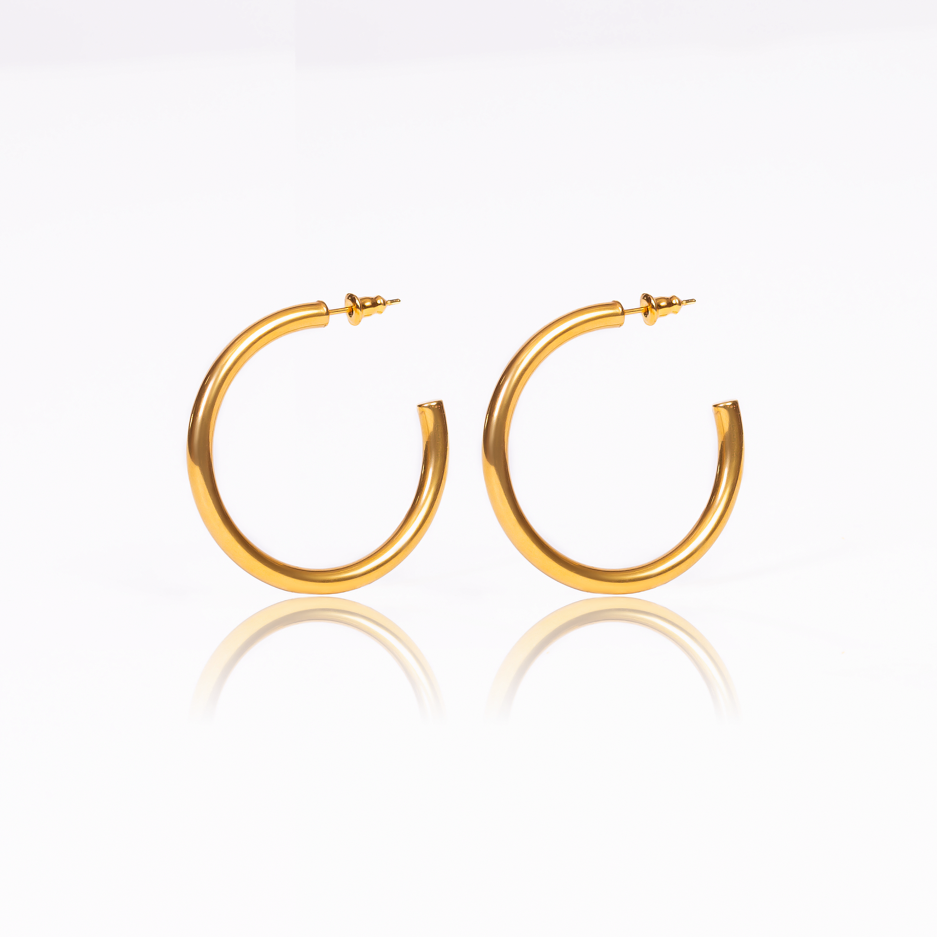 This pair of hoop earrings is the perfect piece to add a classy touch to any outfit. They're a timeless accessory that brings a touch of glamour to everything you dress up or down.  18K gold plated on stainless steel. Hoop size: 42mm