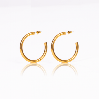 This pair of hoop earrings is the perfect piece to add a classy touch to any outfit. They're a timeless accessory that brings a touch of glamour to everything you dress up or down.  18K gold plated on stainless steel. Hoop size: 42mm