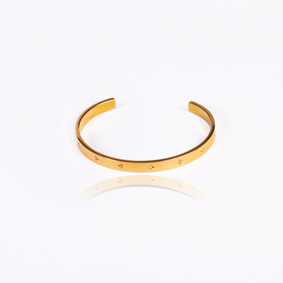 This is a great go-to accessory to have to complete your party outfit or your casual look! Pick this up now and never worry about matching jewelry again! An elegant accessory to be worn alone or stacked with other bracelets.  18K gold plated on stainless steel. Width: 2.4"