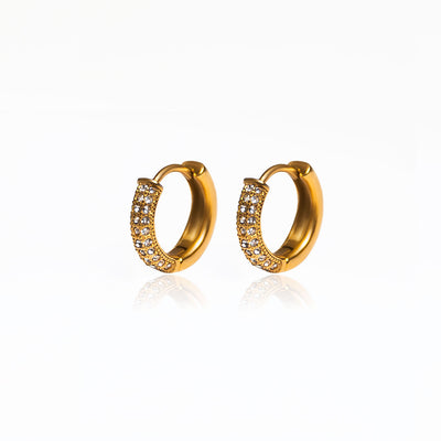 If you love our PARIS HOOP EARRINGS, you're going to fall in love with our MIX HUGGIES. These huggies feature sparkly cubic zirconia (CZ) stones on one half, and the other half resembles your staple gold hoop earring. It's the best of both worlds!  18k gold plated on stainless steel. Hoop size: 15mm All the earrings come in a beautiful jewelry pouch.