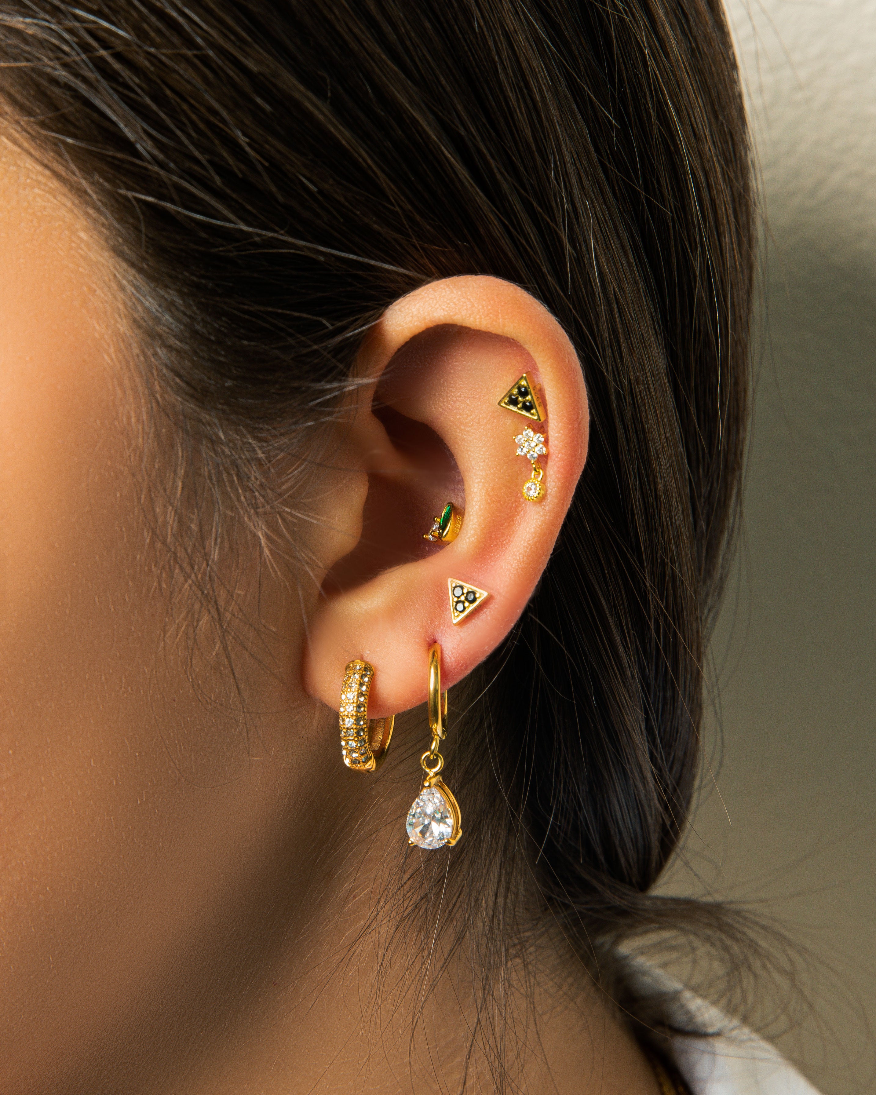 If you love our PARIS HOOP EARRINGS, you're going to fall in love with our MIX HUGGIES. These huggies feature sparkly cubic zirconia (CZ) stones on one half, and the other half resembles your staple gold hoop earring. It's the best of both worlds!  18k gold plated on stainless steel. Hoop size: 15mm All the earrings come in a beautiful jewelry pouch.