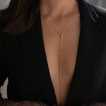 Introducing our DRIP NECKLACE: our most versatile piece yet! This long, thin chain necklace features tiny ball detailing on the ends and a lariat closure to adjust the length to your liking. Slide the closure up to wear it as your shortest layer or slide the closure down to get a longer layer look. Adjust as you wish!  18k gold plated on stainless steel. Length: 39” All the necklaces come in a beautiful jewelry box.