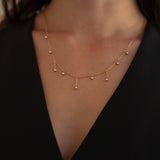 Our AURA NECKLACE features dangly cubic zirconia (CZ) stones and is the perfect necklace stack addition. It's simple with just the right amount of glam. It's stackable, but looks just as good worn on its own.  18k gold plated on stainless steel. Length: 16” Extender: 2” All the necklaces come in a beautiful jewelry box.