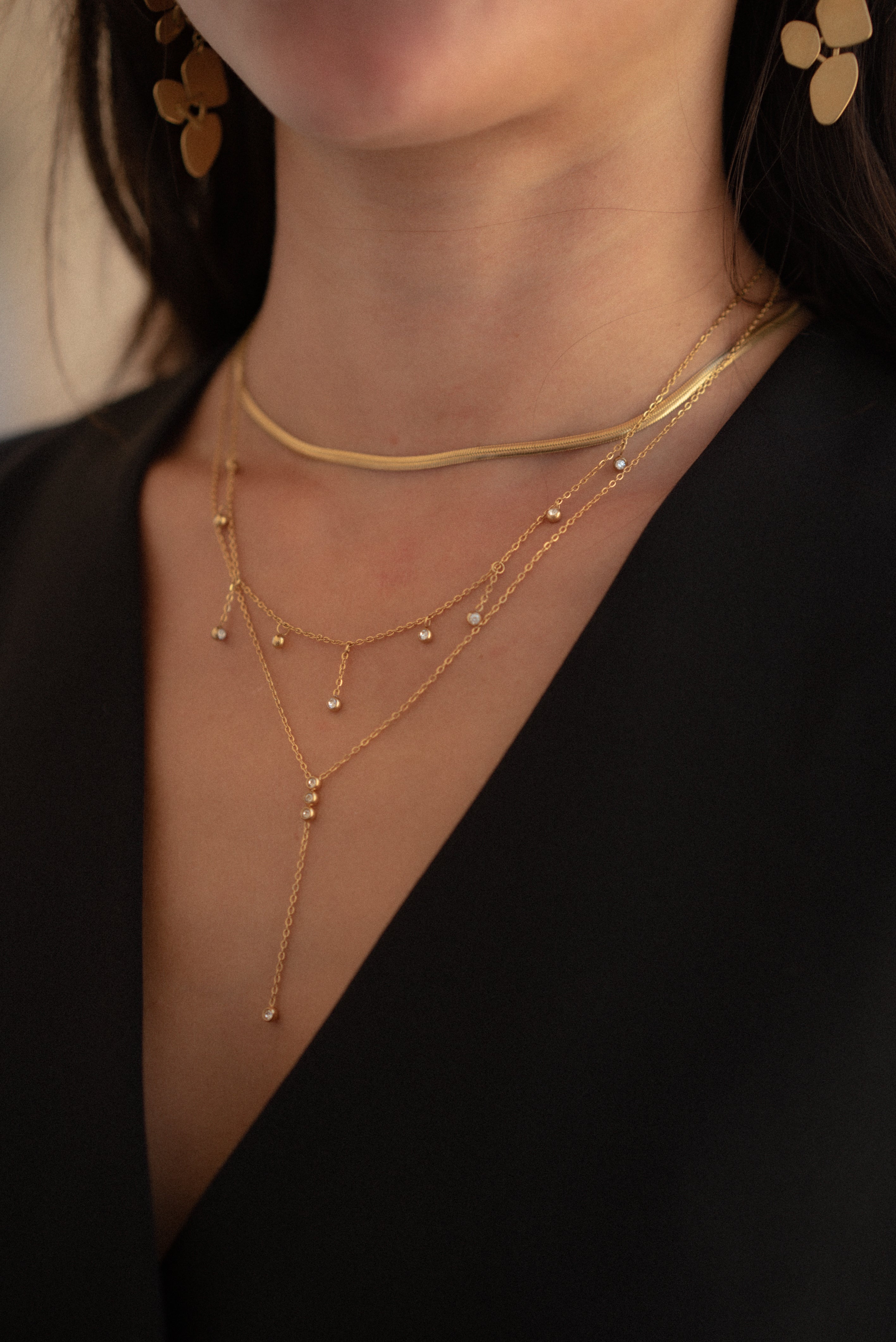 Our SIMPLE LARIAT NECKLACE was made for all you necklace stack lovers. It's simple but features three cubic zirconia (CZ) stones at the focal point to add a pop of sparkle. Wear as is, or layer it with our SENSE or AURA NECKLACE.  18k gold plated on stainless steel. Length: 18” Extender: 2” All the necklaces come in a beautiful jewelry box.